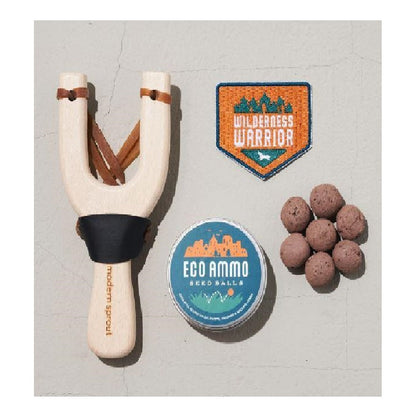 Image showing wooden slingshot ammo seedballs and wilderness warrior patch.