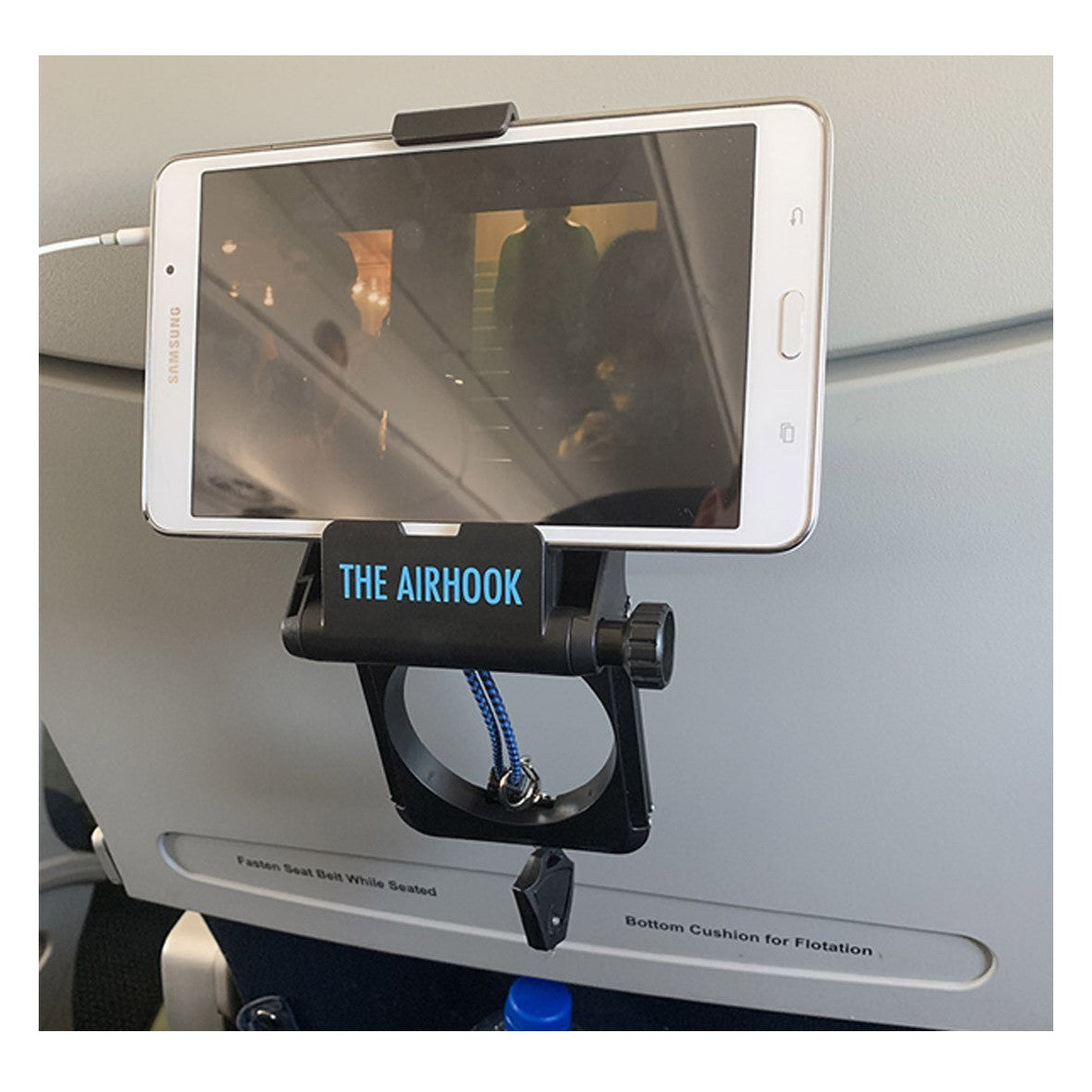 The AIRHOOK shown with a sample smartphone and attached to back of an airplane seat.